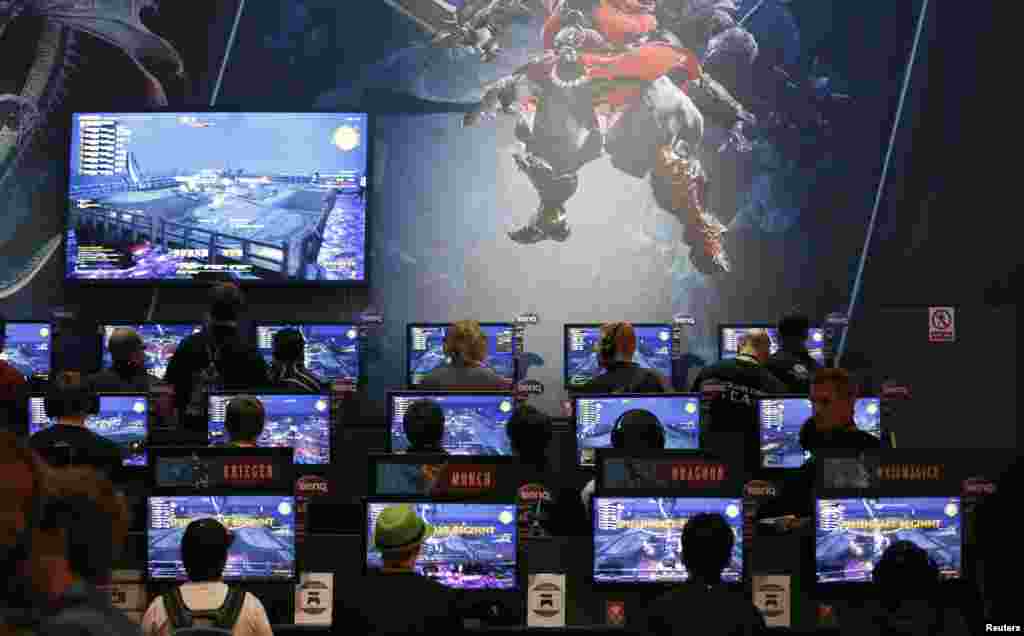 Visitors play video games at the Gamescom 2014 fair in Cologne, Germany. The Gamescom convention, Europe&#39;s largest video games trade fair, runs from Aug. 13 to 17.