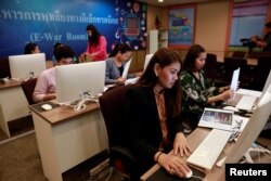 Government staff work as they monitor social media in a social media war room in Bangkok, Thailand, March 8, 2019.