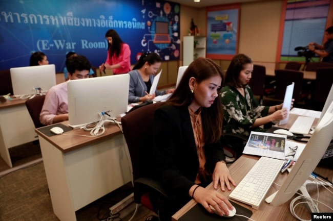 Government staff work as they monitor social media in a social media war room in Bangkok, Thailand, March 8, 2019.