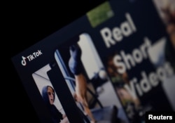 The logo of the TikTok application is seen on a screen.