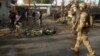 NATO and Afghan troops arrive at the site of a suicide attack in Jalalabad, Afghanistan, March 26, 2013. 