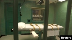 FILE - The death chamber is seen through the steel bars from the viewing room at the state penitentiary in Huntsville, Texas, Sept. 29, 2010.