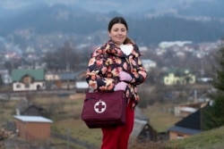 Dr. Viktoria Mahnych, poses for a photo prior to her interview with the Associated Press in Verhovyna village, Ivano-Frankivsk region of Western Ukraine, Wednesday, Jan. 6, 2021. AP Photo)