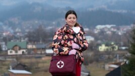Dr. Viktoria Mahnych, poses for a photo prior to her interview with the Associated Press in Verhovyna village, Ivano-Frankivsk region of Western Ukraine, Wednesday, Jan. 6, 2021. AP Photo)