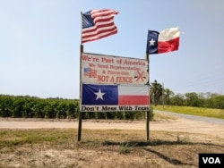 Brownsville, Texas resident Pamela Taylor erected a sign outside her property in protest of the 2006 Secure Fence Act. Although she voted for President Trump in 2016, her philosophy on his plans to build a continuous wall remain unchanged. (R. Taylor/VOA)