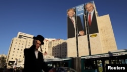 Un hombre pasa frente a un cartel de campaña del partido israelí Likud, con las fotos del presidente de EE.UU. Donald Trump y el primer ministro israelí Benjamín Netanyahu. Jerusalén, 4 de febrero de 2019. Foto REUTERS.