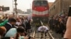 Egyptian wrestler Ashraf Mahrous, better known as Kabonga, pulls a train for nearly 10 meters, 33 feets, at Ramses Station in Cairo, Egypt, as he is watched by Guinness World Record observers, March 13, 2025. 