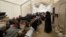 FILE - Displaced people gather inside a tent in the al-Hol camp in northeastern Syria, Dec. 8, 2018. 