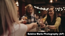 In this January 17, 2019 photo, a bartender serves patrons Rae of Sunshine mocktails at Sans Bar pop up bar at The Factory Luxe in Seattle, a Marnie Rae launch party for National Mocktail Week.