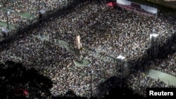 To mark Beijing's Tiananmen Square crackdown in 1989, thousands of people attend an annual candlelight vigil at the Victoria Park in Hong Kong, June 4, 2015.