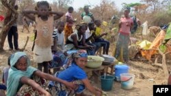 FILE - Refugees from Central Africa sit in the eastern Cameroonian village of Gado Badzere, near the border with Central African Republic.