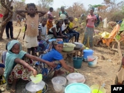 FILE - Refugees from Central Africa sit in the eastern Cameroonian village of Gado Badzere, near the city of Garoua-Boulai, not far from the border with Central Africa.