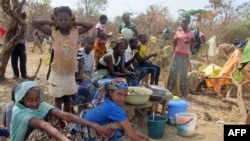 FILE - Refugees from Central Africa sit in the eastern Cameroonian village of Gado Badzere, near the city of Garoua-Boulai, not far from the border with Central Africa Republic.