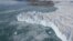  In the center, a rising plume of sediment-laden subglacial meltwater discharge protrudes inot the water surface. Subglacial meltwater discharge is a major component of meltwater runoff, affecting surface mass balance as seen in the massive calving front 