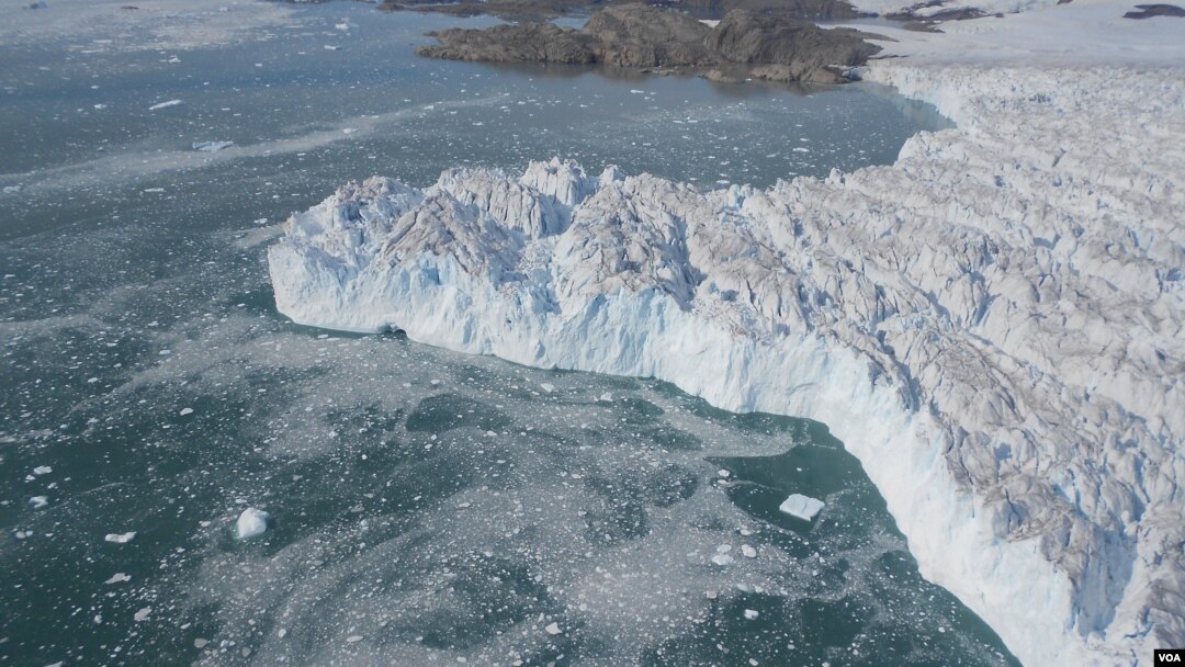 A rising plume of sediment-laden subglacial meltwater discharge protrudes into the water surface, as seen in the massive calving front of the southernmost of four tributaries of Upernavik Icestream, Greenland. [Natural History Museum of Denmark - N.J. Kor