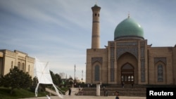 FILE - A boy plays with a kite at Khast Imam square in Tashkent, Uzbekistan.