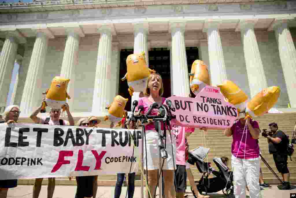 American activist Medea Benjamin, co-founder of the anti-war group Code Pink, holds a sign that reads &quot;Tanks But No Tanks DC Residents,&quot; as she speaks at a news conference, July 2, 2019, in front of the Lincoln Memorial in Washington. The area was near where workers are setting up for President Donald Trump&#39;s &#39;Salute to America&#39; event honoring military branches on Independence Day.