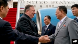 FILE - U.S. Secretary of State Mike Pompeo, second from left, is greeted by North Korean Director of the United Front Department Kim Yong Chol, center, and North Korean Foreign Minister Ri Yong Ho, second from right, as he arrives in Pyongyang, July 6, 2018.