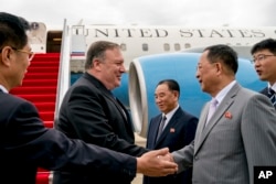 U.S. Secretary of State Mike Pompeo, second from left, is greeted by North Korean Director of the United Front Department Kim Yong Chol, center, and North Korean Foreign Minister Ri Yong Ho, second from right, as he arrives at Sunan International Airport.