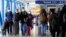 Travelers walk through Terminal 1 at O'Hare International Airport in Chicago, Dec. 30, 2021.