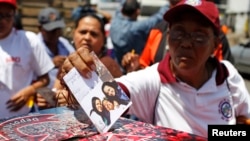 Supporters of Venezuelan President Hugo Chavez line up to put encouraging messages for him in a box outside the military hospital in Caracas Mar. 5, 2013.