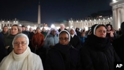 People attend as Cardinal Robert Francis Prevost, Prefect of the Dicastery for Bishops, leads the recitation of the Holy Rosary for Pope Francis' health in St Peter's Square at the Vatican, March 3, 2025. 