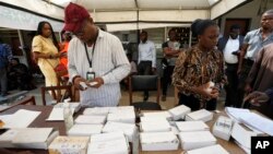 Electoral officials checks permanent voters cards at a distribution center ahead of the Feb. 2023 Presidential elections in Lagos, Nigeria, Jan. 11, 2023. 