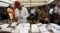 Electoral officials checks permanent voters cards at a distribution center ahead of the Feb. 2023 Presidential elections in Lagos, Nigeria, Jan. 11, 2023. 