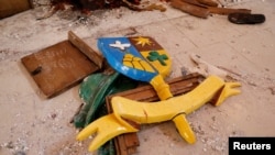 FILE: Broken pieces of furniture are seen on the ground, following an attack by gunmen on worshippers during a Sunday service mass at St. Francis Catholic Church, in Owo. Taken 6.6.2022