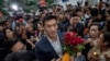 Thanathorn Juangroongruangkit, center, leader of the Future Forward Party is surrounded by his supporters as he arrives at Constitutional Court in Bangkok, Thailand, Nov. 20, 2019. 