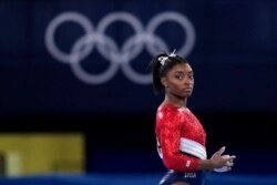Simone Biles, of the United States, waits to perform on the vault during the artistic gymnastics women's final at the 2020 Summer Olympics, July 27, 2021, in Tokyo.