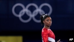 Simone Biles, of the United States, waits to perform on the vault during the artistic gymnastics women's final at the 2020 Summer Olympics, July 27, 2021, in Tokyo.