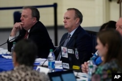 New College of Florida's interim President Richard Corcoran, center, listens during a meeting of the college's board of trustees, alongside trustee Matthew Spalding, left, Tuesday, Feb. 28. (AP Photo/Rebecca Blackwell, File)