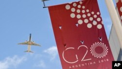 A jetliner flies over the G-20 summit venue at the Costa Salguero Center in Buenos Aires, Argentina, Nov. 28, 2018.