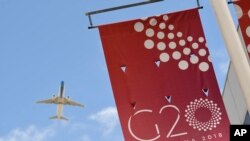 A jetliner flies over the G20 summit venue at the Costa Salguero Center in Buenos Aires, Argentina, Nov. 28, 2018.