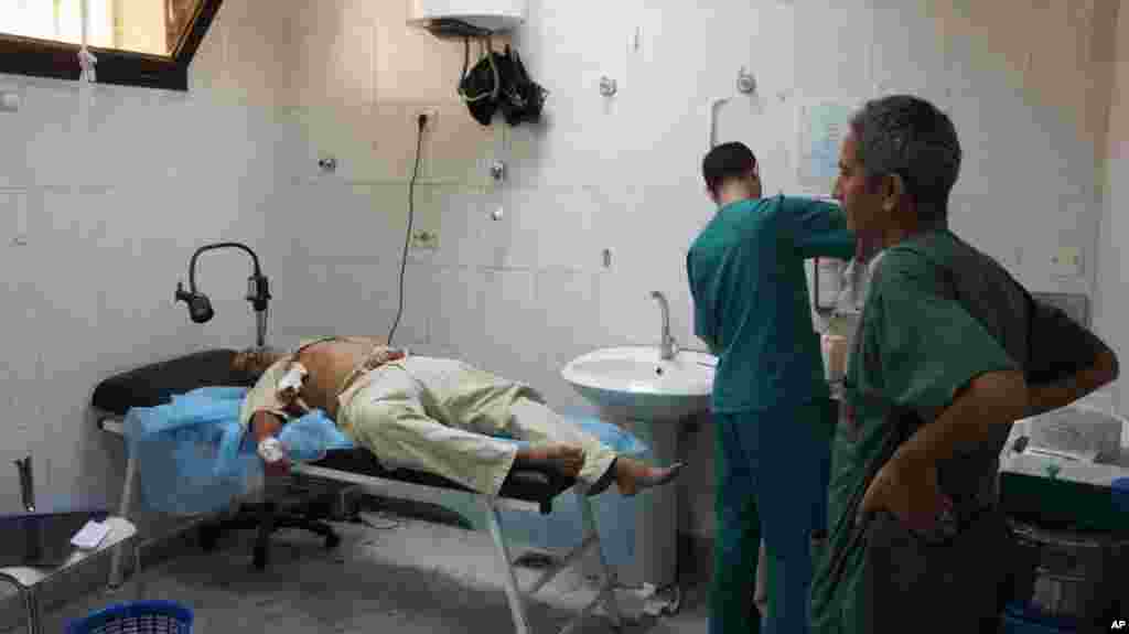 Receiving treatment after a gunshot wound, at the Zawiya Hospital VOA Photo - E. Arrott)