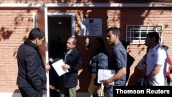 Venezuelans line up at the Chile Consulate to get migration documents in La Paz, Bolivia, July 1, 2019.