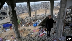 FILE - A Palestinian man stands in rubble of his house which was destroyed during the conflict between Israel and Hamas, in Gaza City's Shijaiyah neighborhood, Nov. 24, 2014.