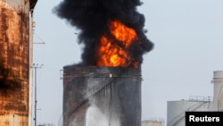 Firefighters attempt to put out a fire at the Zahrani oil facility in southern Lebanon, Oct. 11, 2021. 