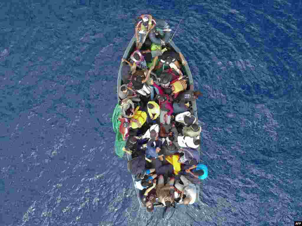 An aerial photo shows a boat carrying migrants stranded in the Strait of Gibraltar before being rescued by the Spanish Guardia Civil and the Salvamento Maritimo sea search and rescue agency, Sept. 8, 2018.