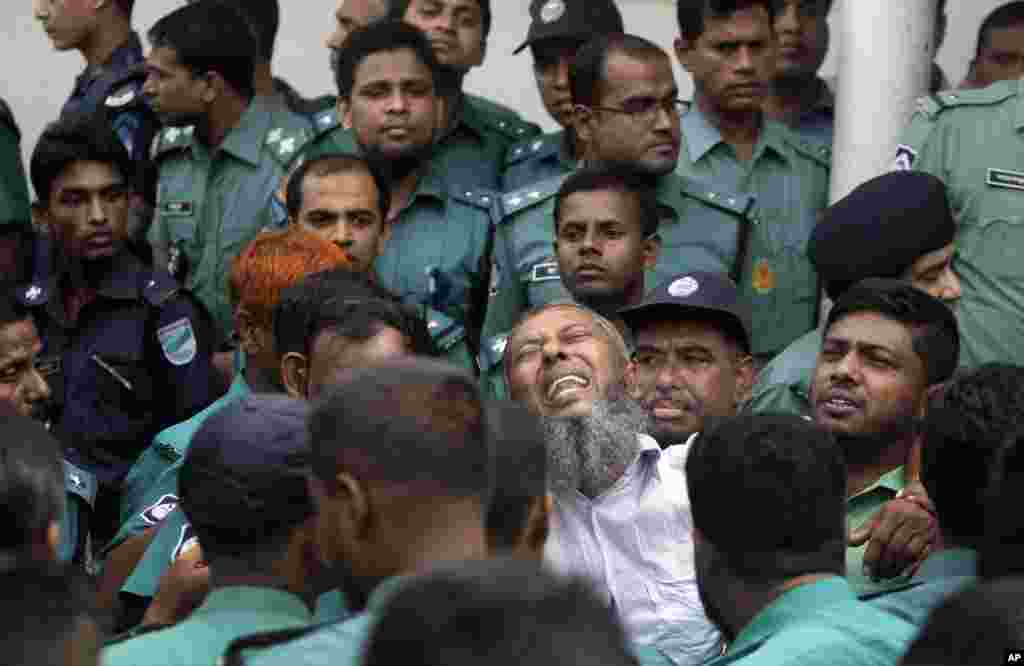 A border guard who was sentenced to death reacts as he leaves a special court in Dhaka, Nov. 5, 2013.