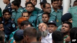 A border guard who was sentenced to death reacts as he leaves a special court in Dhaka, Nov. 5, 2013.