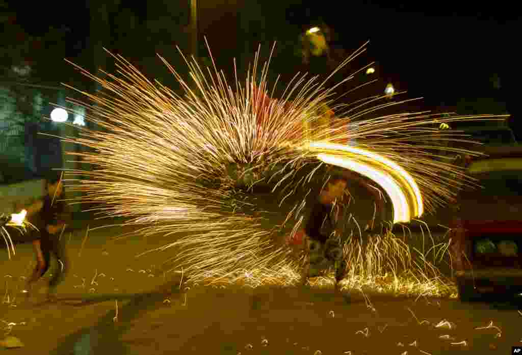 Egyptians play with fire works as they celebrate the holy month of Ramadan in Cairo, Egypt, June 7, 2016.