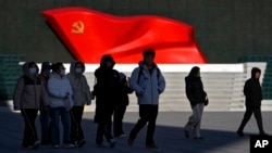 People walk past a sculpture of the Chinese Communist Party flag at the Museum of the Communist Party of China, in Beijing, Jan. 14, 2025. 