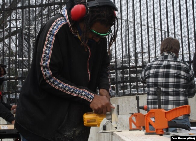 A student works on a project outside the mobile woodshop