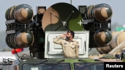 (FILE) Pakistani Army soldier salutes while standing on an air defence missile system during Pakistan Day military parade in Islamabad, Pakistan, March 23, 2022. 