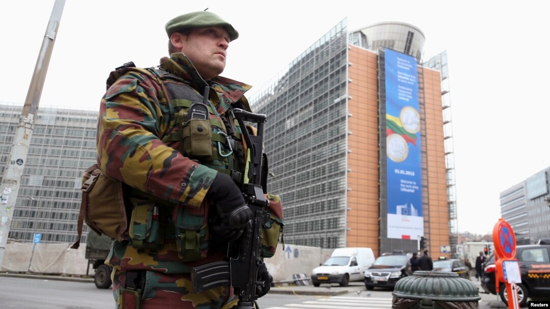 FILE - A Belgian soldier, one of hundreds deployed to guard potential terror targets, stands outside the European Commission headquarters in Brussels, Jan. 21, 2015. 