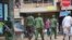 Ugandan police and other security forces chase people off the streets to avoid unrest, as part of measures to prevent the potential spread of coronavirus disease, in Kampala, Uganda, March 26, 2020. 