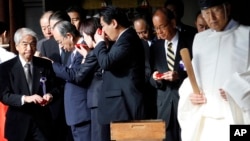 Group of Japanese lawmakers sip sake as they observe a Shinto ritual, Yasukuni Shrine, Tokyo, Oct. 18, 2013.