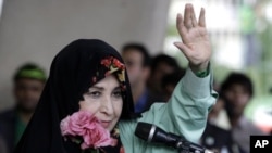 In this Tuesday, June 9, 2009 file photo, Zahra Rahnavard, the wife of reformist candidate Mir Hossein Mousavi, waves to the people during a rally at Heidarnia stadium, during the final days of the election race in Tehran, Iran.